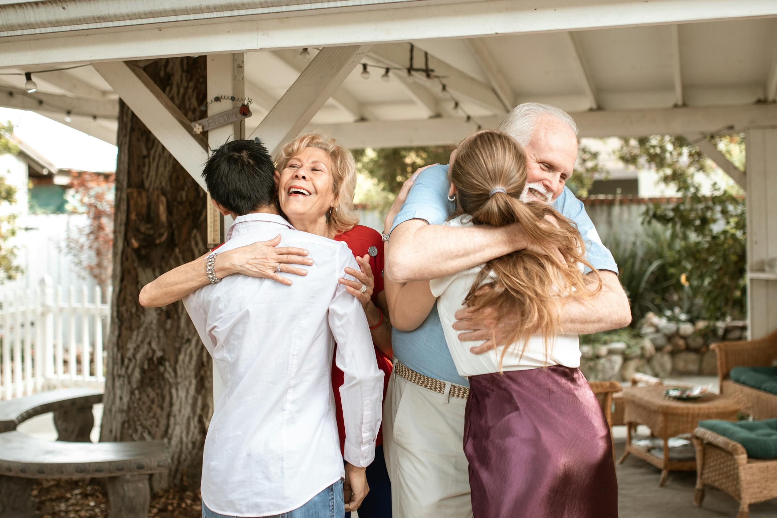 Multigenerational family embracing warmly — the invisible work that holds everything together